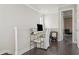 Open office nook area with dark wood flooring and a glass computer desk at 224 S Audubon Ave, Tampa, FL 33609