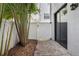Private outdoor patio area with lush bamboo and a white gate near the sliding glass door at 224 S Audubon Ave, Tampa, FL 33609