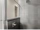 Modern shower with gray tile surround, glass partition, and updated fixtures at 224 S Audubon Ave, Tampa, FL 33609