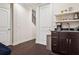 Hallway wet bar featuring a dark wood vanity, coffee maker, and shelving at 224 S Audubon Ave, Tampa, FL 33609