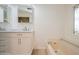 Bathroom with white cabinetry, marble countertops, bathtub, and stained glass windows at 238 Pelican N Dr, Oldsmar, FL 34677