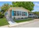 Charming home with blue shutters, manicured lawn, and well maintained landscaping at 238 Pelican N Dr, Oldsmar, FL 34677