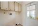 The laundry room includes storage cabinets and a door with glass panes at 238 Pelican N Dr, Oldsmar, FL 34677