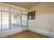 An enclosed sunroom featuring carpet flooring and multiple windows for ample natural light at 238 Pelican N Dr, Oldsmar, FL 34677