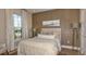 Comfortable bedroom showcases stylish decor, including paneled walls, plush bedding, and ample natural light at 29548 Zupetta Ln, Wesley Chapel, FL 33543