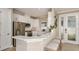Beautiful kitchen with stainless steel appliances, white cabinets, breakfast bar, and ample counter space at 29548 Zupetta Ln, Wesley Chapel, FL 33543
