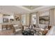 Comfortable living room featuring modern furniture, neutral tones, and an open layout to the kitchen at 29548 Zupetta Ln, Wesley Chapel, FL 33543