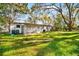 Large backyard view showcasing the yard and the screened-in porch at 3005 E Sligh Ave, Tampa, FL 33610
