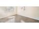 Sunlit bedroom with two windows, flooring, and neutral colored walls at 3005 E Sligh Ave, Tampa, FL 33610
