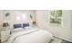 Cozy bedroom featuring two windows, decorative art, and night stands with lamps at 3005 E Sligh Ave, Tampa, FL 33610