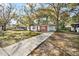 Inviting single-Gathering home with brick accents, a covered carport, and a well-manicured front yard at 3005 E Sligh Ave, Tampa, FL 33610