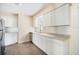 Modern kitchen with white cabinets, stainless steel appliances, and ample counter space at 3005 E Sligh Ave, Tampa, FL 33610