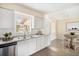 Bright kitchen featuring sleek white cabinetry, stainless steel appliances, and ample counter space at 3005 E Sligh Ave, Tampa, FL 33610