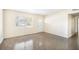 Bright Living Room Featuring Large Window, Neutral Paint, and Polished Concrete Flooring at 3005 E Sligh Ave, Tampa, FL 33610