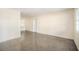 Neutrally painted living room with a large window, a white entry door, and polished concrete flooring at 3005 E Sligh Ave, Tampa, FL 33610