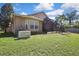 The backyard has a generator and screened patio with lush lawn and palm trees at 3033 Marble Crest Dr, Land O Lakes, FL 34638