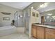 Bright bathroom with vanity, soaking tub, and walk-in shower showcasing comfort and convenience at 3033 Marble Crest Dr, Land O Lakes, FL 34638