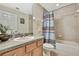 Bright bathroom featuring a ceramic tile surround tub, wood cabinets and neutral paint at 3033 Marble Crest Dr, Land O Lakes, FL 34638