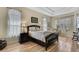 Calm bedroom with tray ceilings, wood floors, and plenty of natural light at 3033 Marble Crest Dr, Land O Lakes, FL 34638