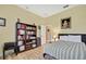 Bedroom with light wood floors, a striped bedspread, and a bookcase at 3033 Marble Crest Dr, Land O Lakes, FL 34638