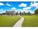 A charming walkway leads to the community pool, clubhouse, and playground amenities on a sunny day at 3033 Marble Crest Dr, Land O Lakes, FL 34638