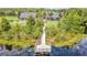 Scenic view of a wooden pier extending into a pond, connecting to community amenities like a pool and playground at 3033 Marble Crest Dr, Land O Lakes, FL 34638