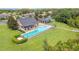 Overhead view of a community pool with a playground, a picnic area, and well-maintained green spaces at 3033 Marble Crest Dr, Land O Lakes, FL 34638