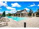 Relaxing community pool area with lounge chairs, umbrellas, and a covered seating area for residents at 3033 Marble Crest Dr, Land O Lakes, FL 34638