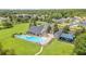 Aerial shot showcasing a community pool, a playground, and lush green spaces in a neighborhood at 3033 Marble Crest Dr, Land O Lakes, FL 34638