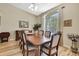 Formal dining room featuring a large window and hardwood floors at 3033 Marble Crest Dr, Land O Lakes, FL 34638