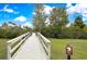 Wooden walkway and signage for the 'Approved Fishing Pond' offering a serene spot for recreation at 3033 Marble Crest Dr, Land O Lakes, FL 34638