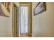 Hallway with warm lighting, beautiful wall art, and white door with delicate sheer curtain at 3033 Marble Crest Dr, Land O Lakes, FL 34638