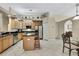 Well-lit kitchen with stainless appliances, center island, tile floors and wooden cabinets at 3033 Marble Crest Dr, Land O Lakes, FL 34638