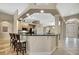 Open kitchen bar with barstool seating and black granite countertops overlooking the kitchen at 3033 Marble Crest Dr, Land O Lakes, FL 34638
