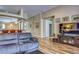 Large living room with hardwood floors and a TV console featuring multiple forms of media at 3033 Marble Crest Dr, Land O Lakes, FL 34638