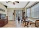 Living room features wood floors, bay window, glass-enclosed porch, and natural light at 3033 Marble Crest Dr, Land O Lakes, FL 34638