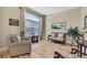 Bright living room with hardwood floors, large window, and classic decor at 3033 Marble Crest Dr, Land O Lakes, FL 34638