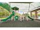 Bright and fun playground featuring multiple slides and climbing structures under a protective shade at 3033 Marble Crest Dr, Land O Lakes, FL 34638