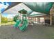 Shaded playground area with slides, climbing structures, and a picnic table, perfect for Gathering fun at 3033 Marble Crest Dr, Land O Lakes, FL 34638