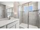 Modern bathroom features a glass-enclosed shower, decorative tile, and a sleek vanity at 30903 Quail Caper Cir, San Antonio, FL 33576