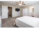 Relaxing bedroom with neutral carpet, ceiling fan, ensuite bathroom, and generous closet space at 30903 Quail Caper Cir, San Antonio, FL 33576
