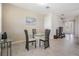 Bright dining area with a glass-top table, tiled floor, and access to other living spaces at 30903 Quail Caper Cir, San Antonio, FL 33576