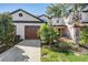 Charming townhome featuring a well-maintained lawn and a two-car garage, inviting curb appeal at 30903 Quail Caper Cir, San Antonio, FL 33576