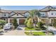 Charming townhome featuring a well-manicured lawn, mature trees, and attached two-car garage at 30903 Quail Caper Cir, San Antonio, FL 33576