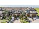 Beautiful townhome exterior with a two-car garage and meticulously landscaped front yard at 30903 Quail Caper Cir, San Antonio, FL 33576