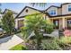 Charming townhome featuring a well-manicured lawn and welcoming entryway at 30903 Quail Caper Cir, San Antonio, FL 33576