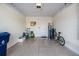 Clean, spacious two-car garage with a light-colored, sealed concrete floor, and white block walls at 30903 Quail Caper Cir, San Antonio, FL 33576