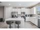 Modern kitchen with stainless steel appliances, white cabinets, and a center island at 30903 Quail Caper Cir, San Antonio, FL 33576