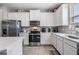 Well-lit modern kitchen featuring stainless steel appliances and ample cabinet space at 30903 Quail Caper Cir, San Antonio, FL 33576