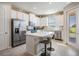 Modern kitchen featuring stainless steel appliances, an island, and ample counter space at 30903 Quail Caper Cir, San Antonio, FL 33576